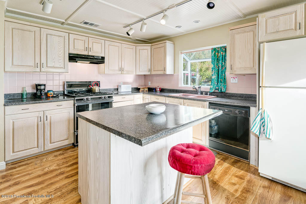 4329 El Prieto Road Altadena, CA 91001 - Photo 3 of 28 a kitchen with stainless steel appliances granite countertop a sink a stove and a refrigerator