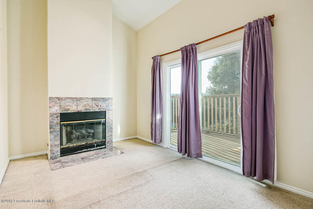 4329 El Prieto Road Altadena, CA 91001 - Photo 7 of 28 a view of a livingroom with a fireplace and window