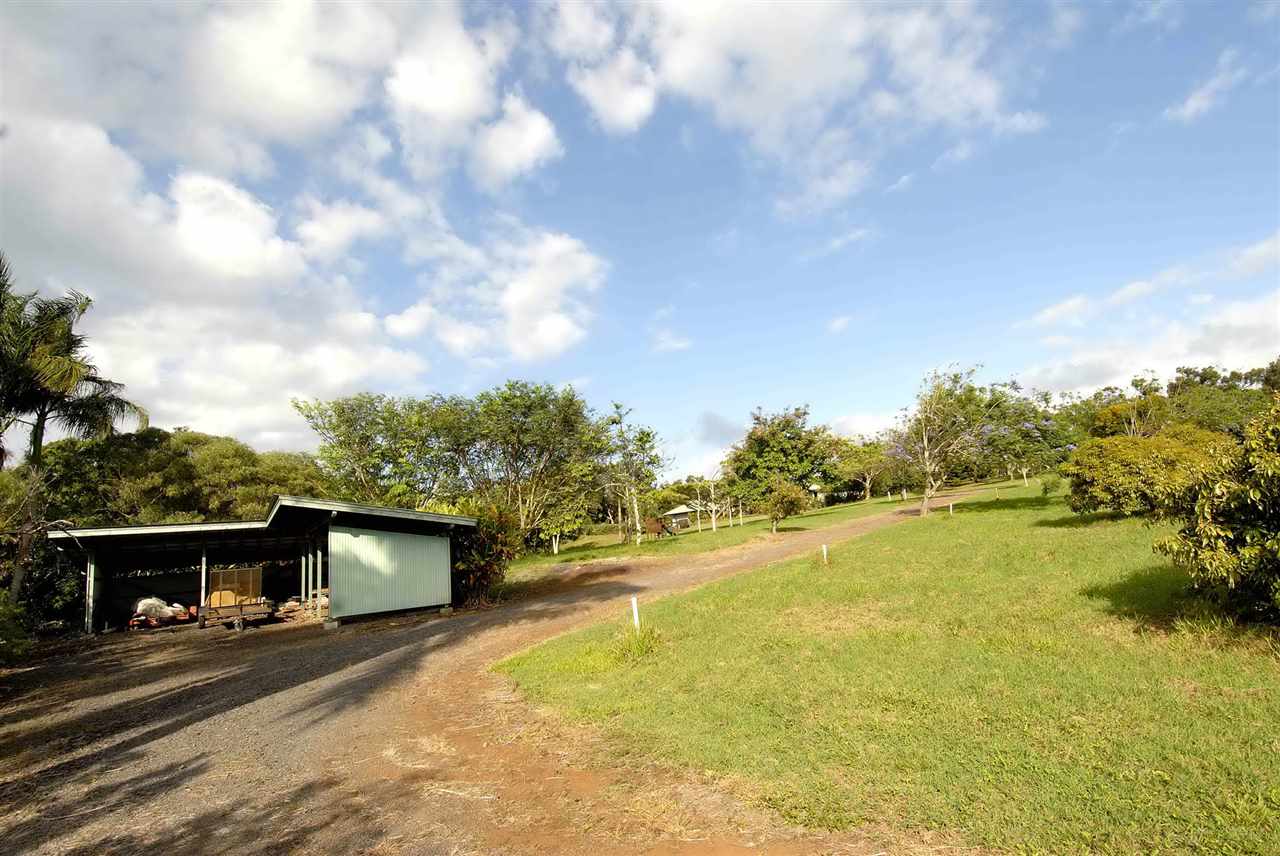913 Hog Back Road Haiku, HI 96708 - Photo 17 of 18 a view of a house with a yard and garage