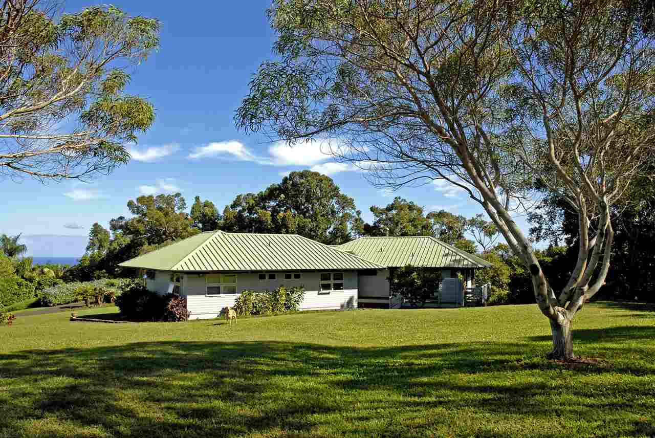 913 Hog Back Road Haiku, HI 96708 - Photo 3 of 18 a view of a big house with a big yard and large trees