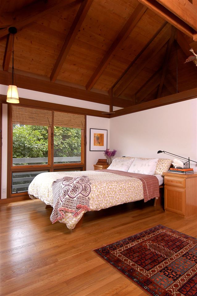 913 Hog Back Road Haiku, HI 96708 - Photo 6 of 18 a bed sitting in a spacious bedroom next to a window