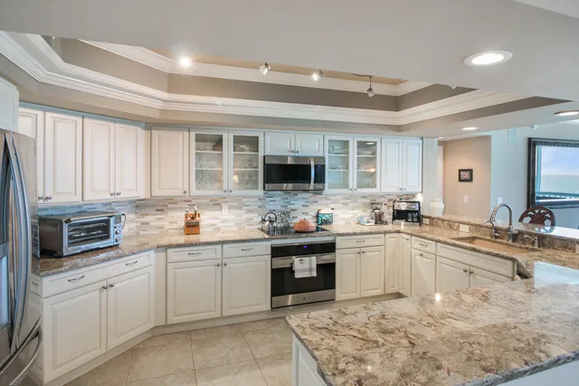a kitchen with stainless steel appliances granite countertop a sink and stove top oven