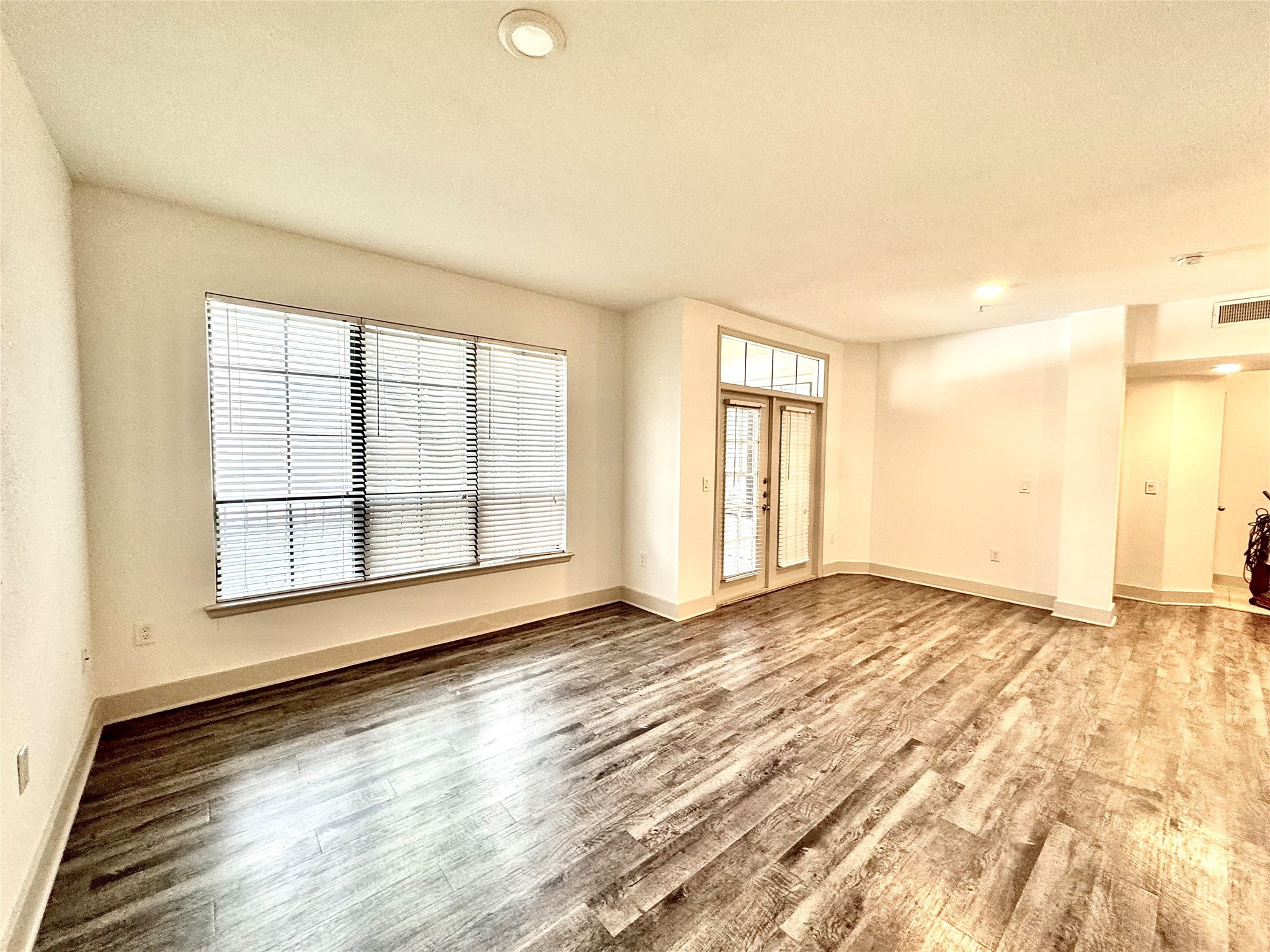 2222 Smith Street, Unit 225 Houston, TX 77002 - Photo 1 of 19 a view of an empty room with wooden floor and a window