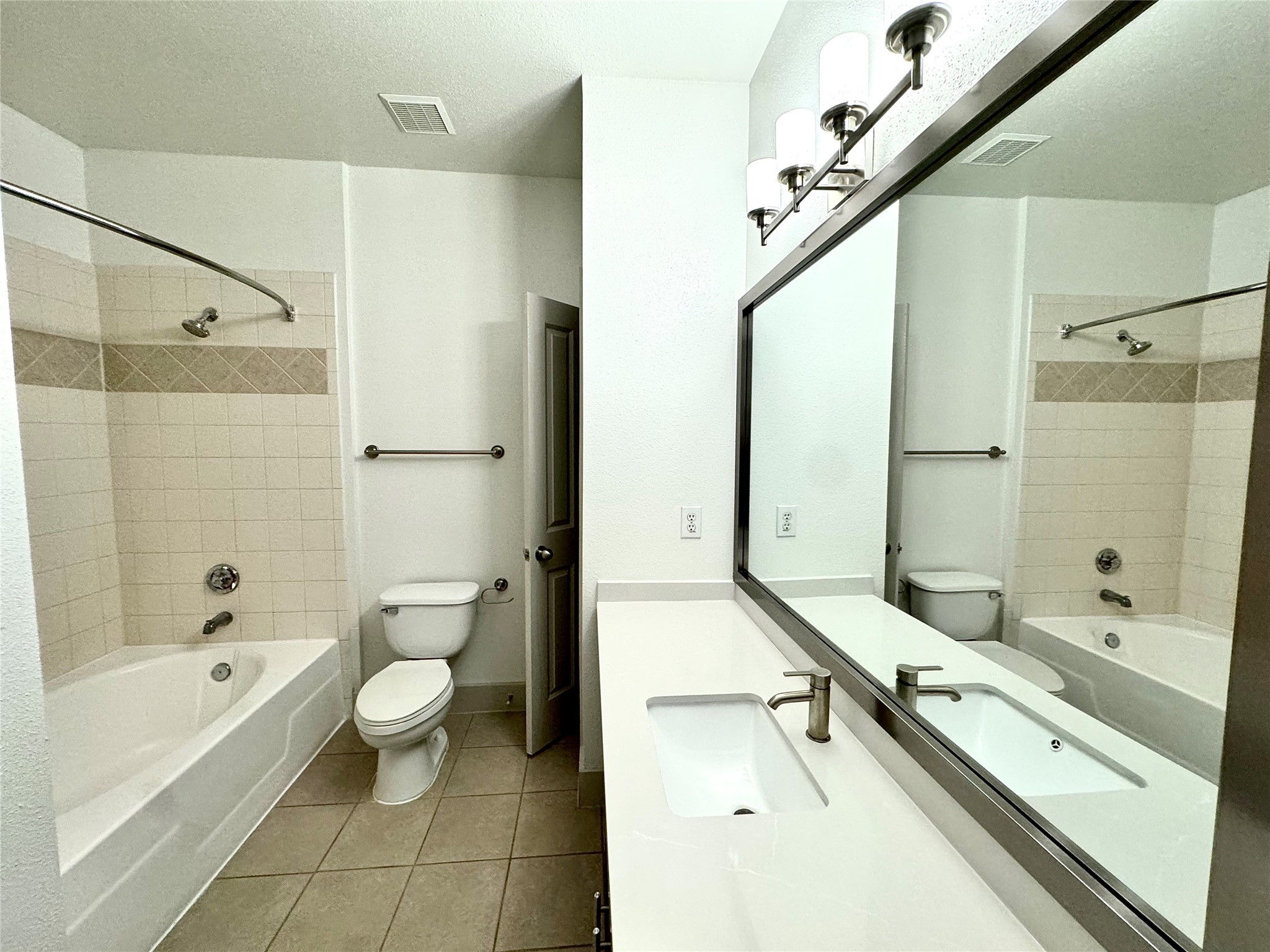 2222 Smith Street, Unit 225 Houston, TX 77002 - Photo 6 of 19 a bathroom with a bathtub shower sink mirror and toilet