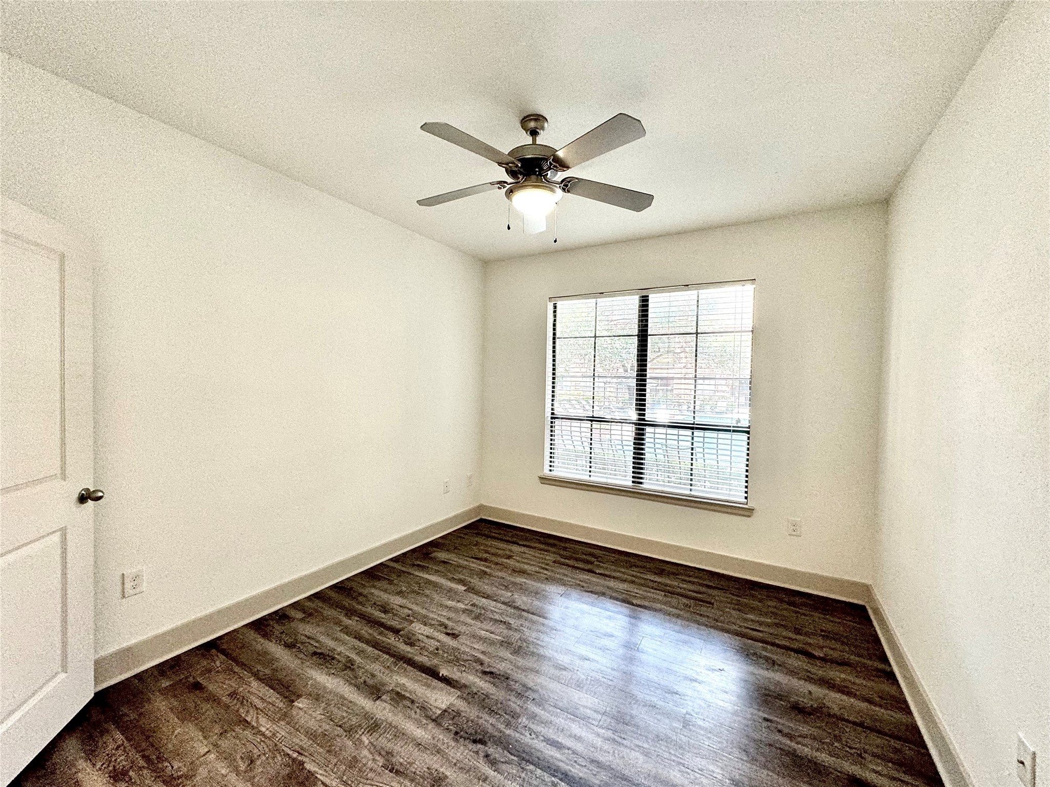2222 Smith Street, Unit 225 Houston, TX 77002 - Photo 8 of 19 a view of an empty room with wooden floor and a window