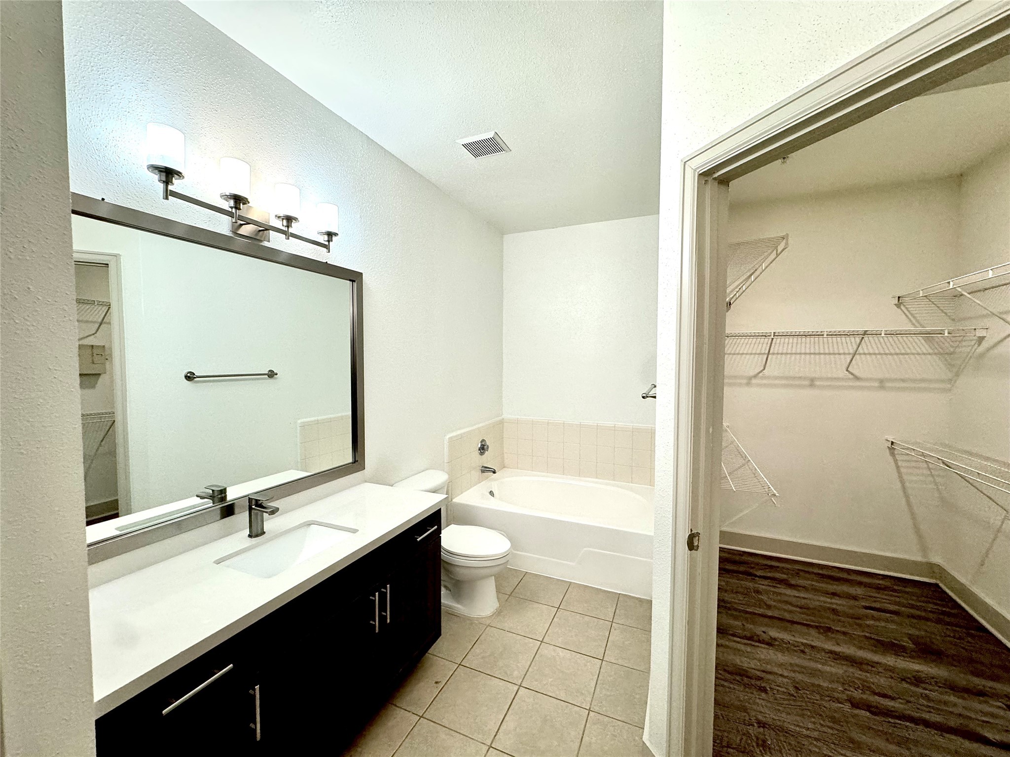 2222 Smith Street, Unit 225 Houston, TX 77002 - Photo 9 of 19 a bathroom with a double vanity sink a toilet and a shower
