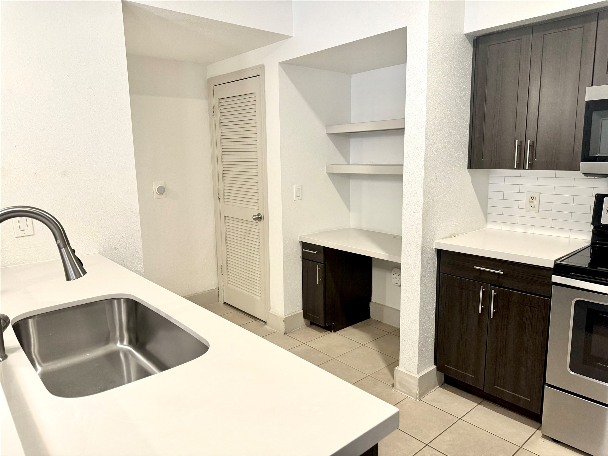 2222 Smith Street, Unit 225 Houston, TX 77002 - Photo 10 of 19 a kitchen with a sink and a refrigerator