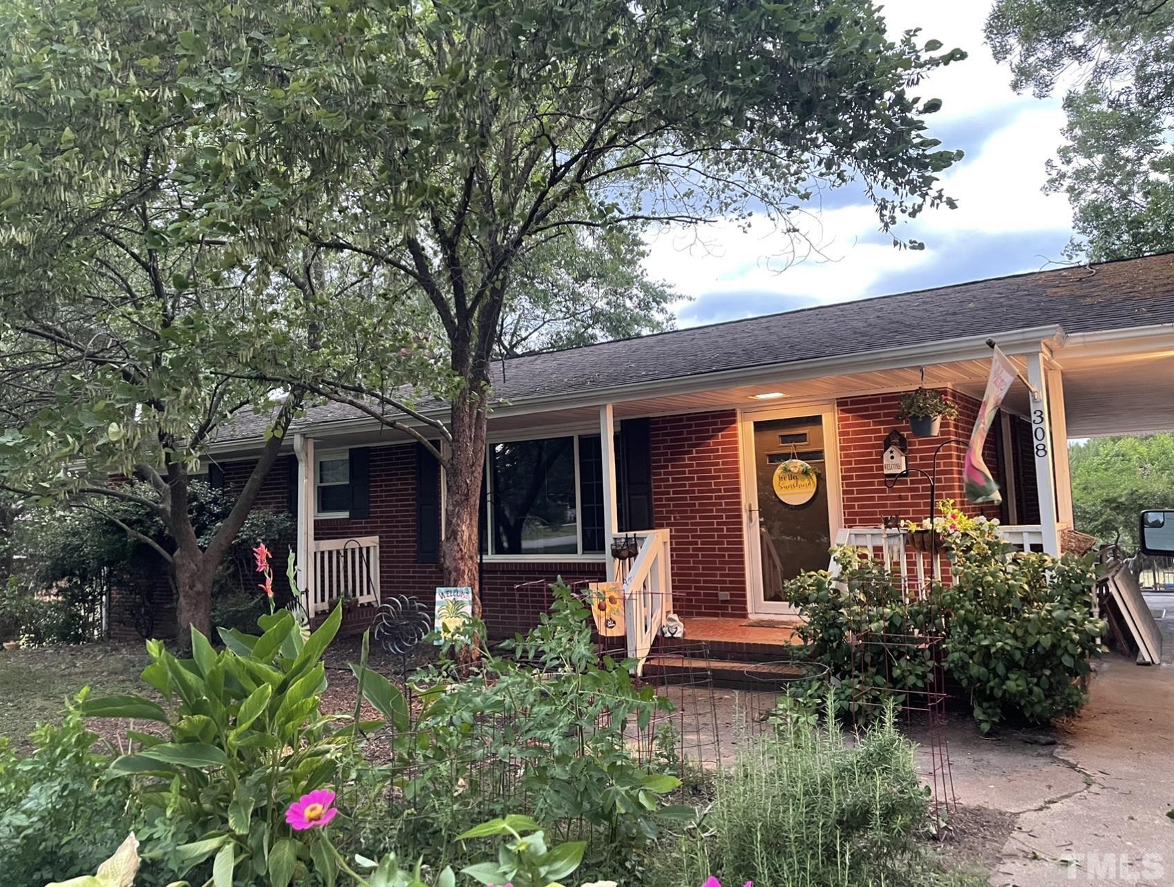 front view of a house with potted plants