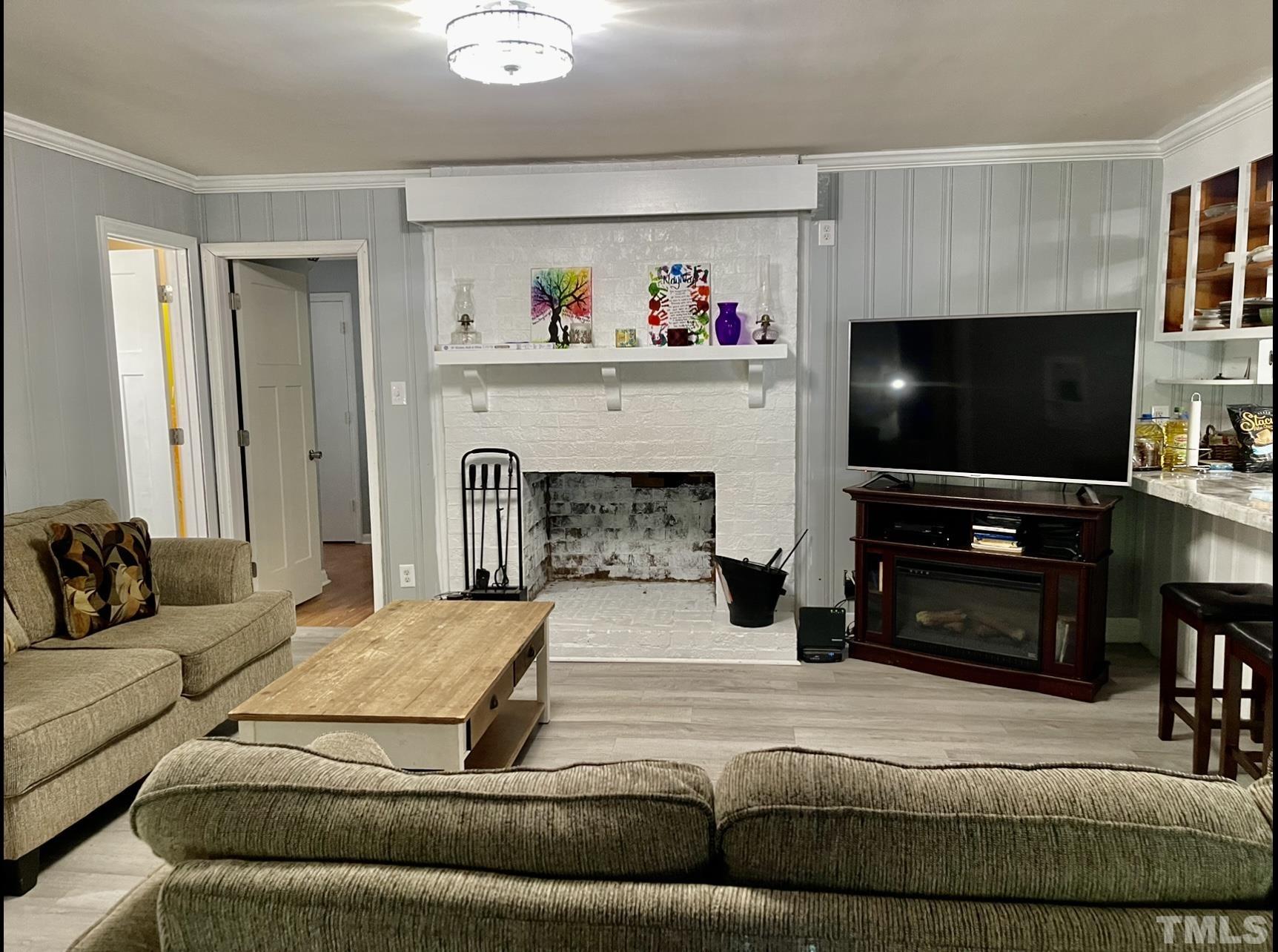 308 Parham Road Henderson, NC 27536 - Photo 11 of 27 a living room with furniture and a flat screen tv