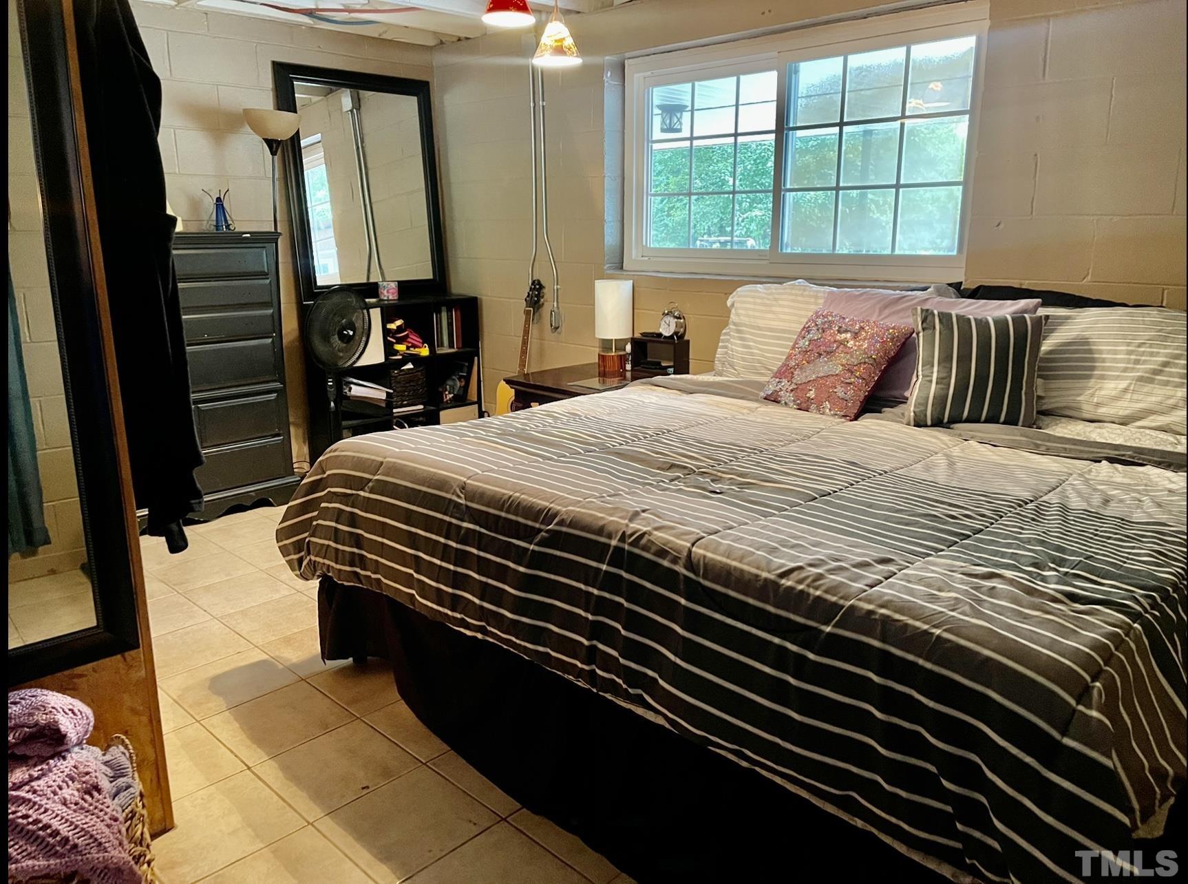 308 Parham Road Henderson, NC 27536 - Photo 16 of 27 a bedroom with a bed and dresser with mirror