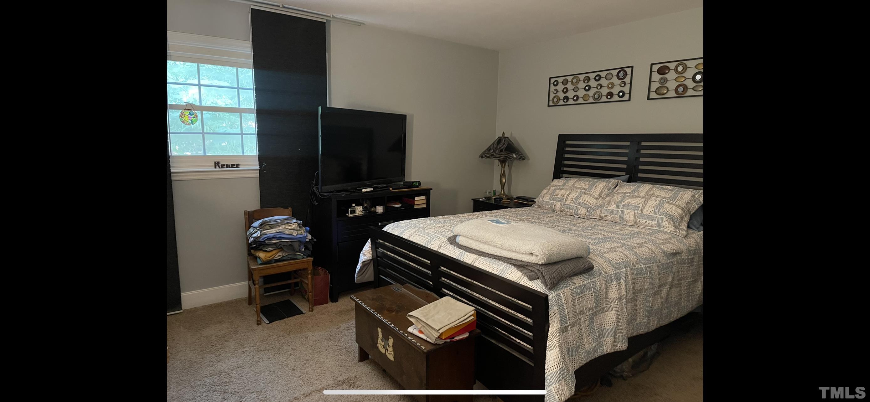 308 Parham Road Henderson, NC 27536 - Photo 20 of 27 a bedroom with a bed and a flat screen tv