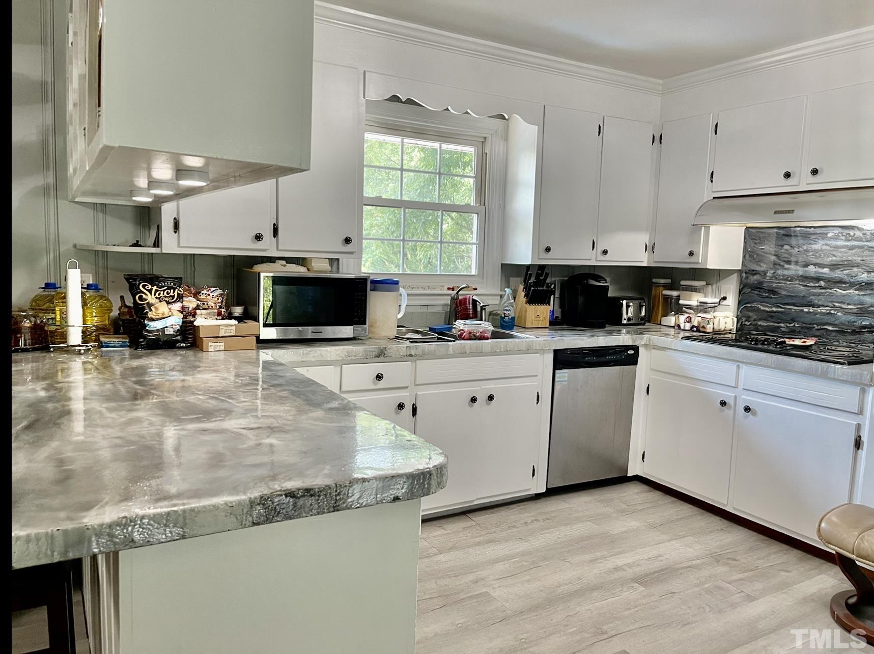 308 Parham Road Henderson, NC 27536 - Photo 8 of 27 a kitchen with stainless steel appliances granite countertop a sink a stove and cabinets