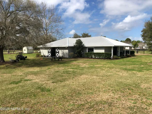 a view of a house with a yard and sitting area