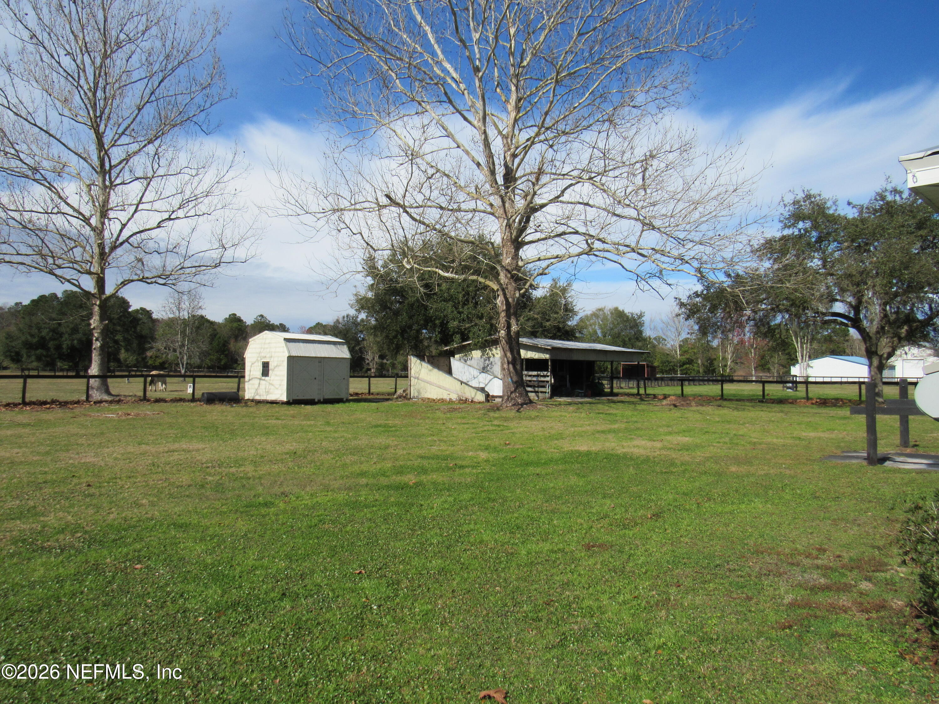 5100 Silo Road St. Augustine, FL 32092 - Photo 4 of 9 a front view of a house with a garden and trees
