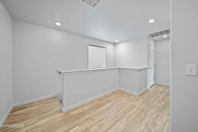 a bedroom with a bed wooden floor and window
