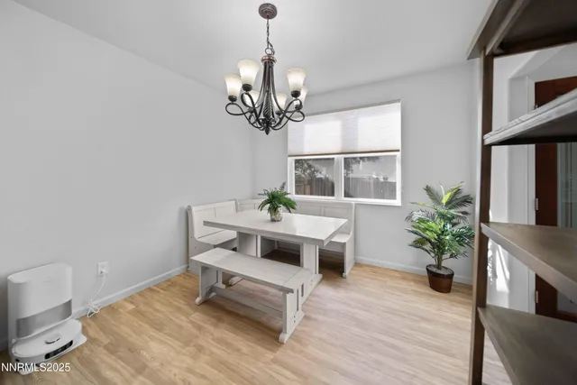 a living room with wooden floor furniture and a chandelier