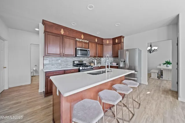 a large kitchen with a center island appliances and cabinets