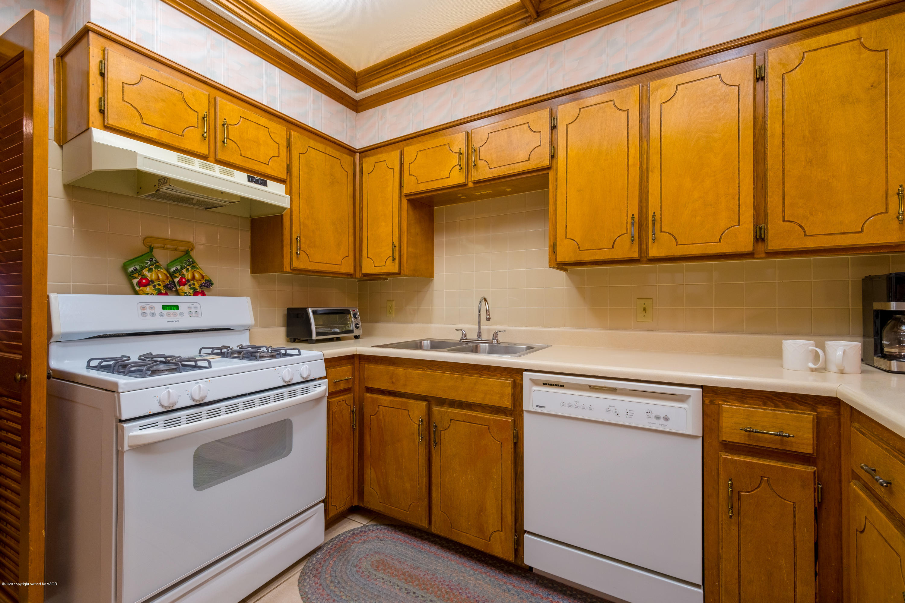 5718 South Fannin Street Amarillo, TX 79110 - Photo 11 of 31 a kitchen with a sink cabinets and appliances