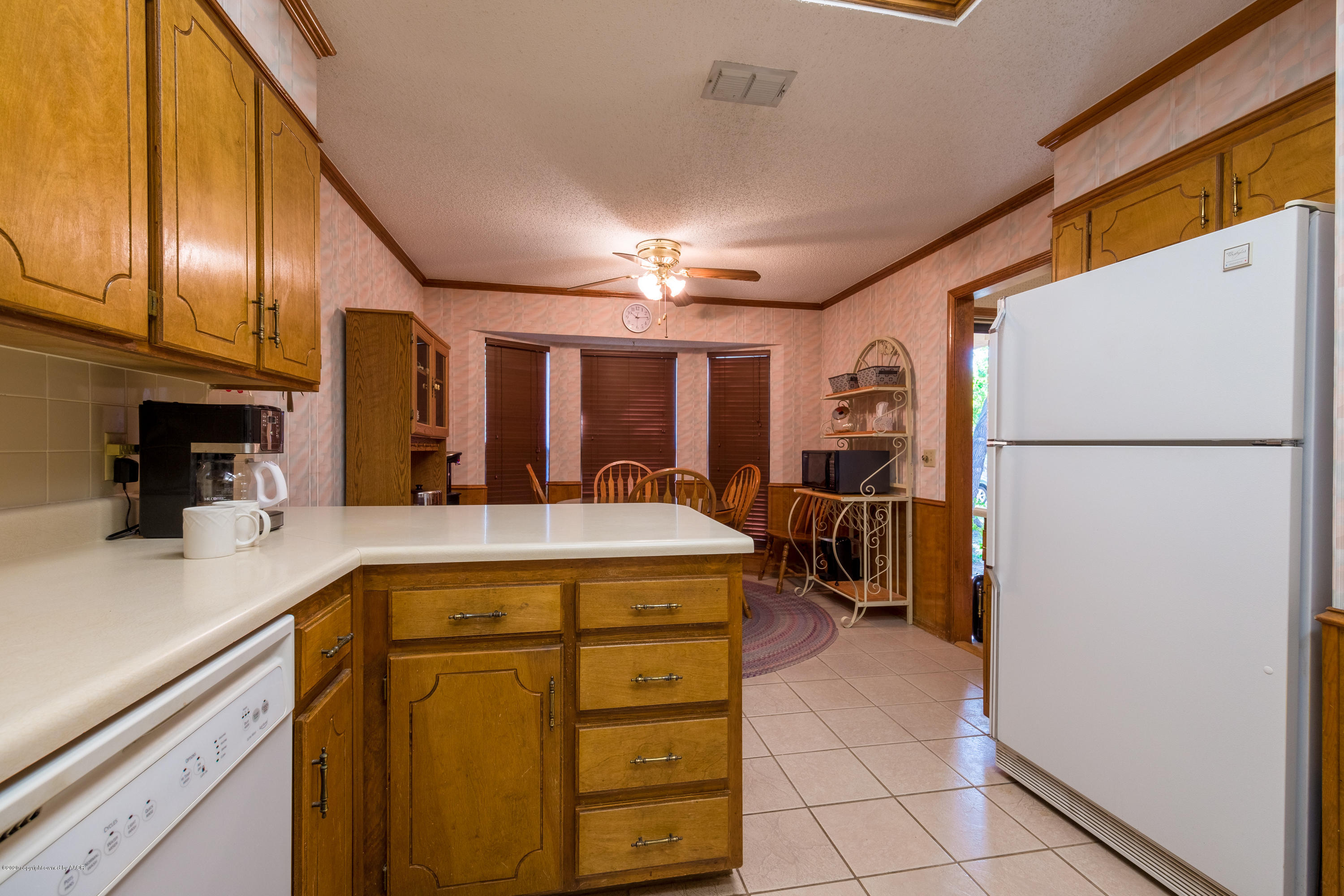 5718 South Fannin Street Amarillo, TX 79110 - Photo 12 of 31 a kitchen with a refrigerator a stove top oven and a sink