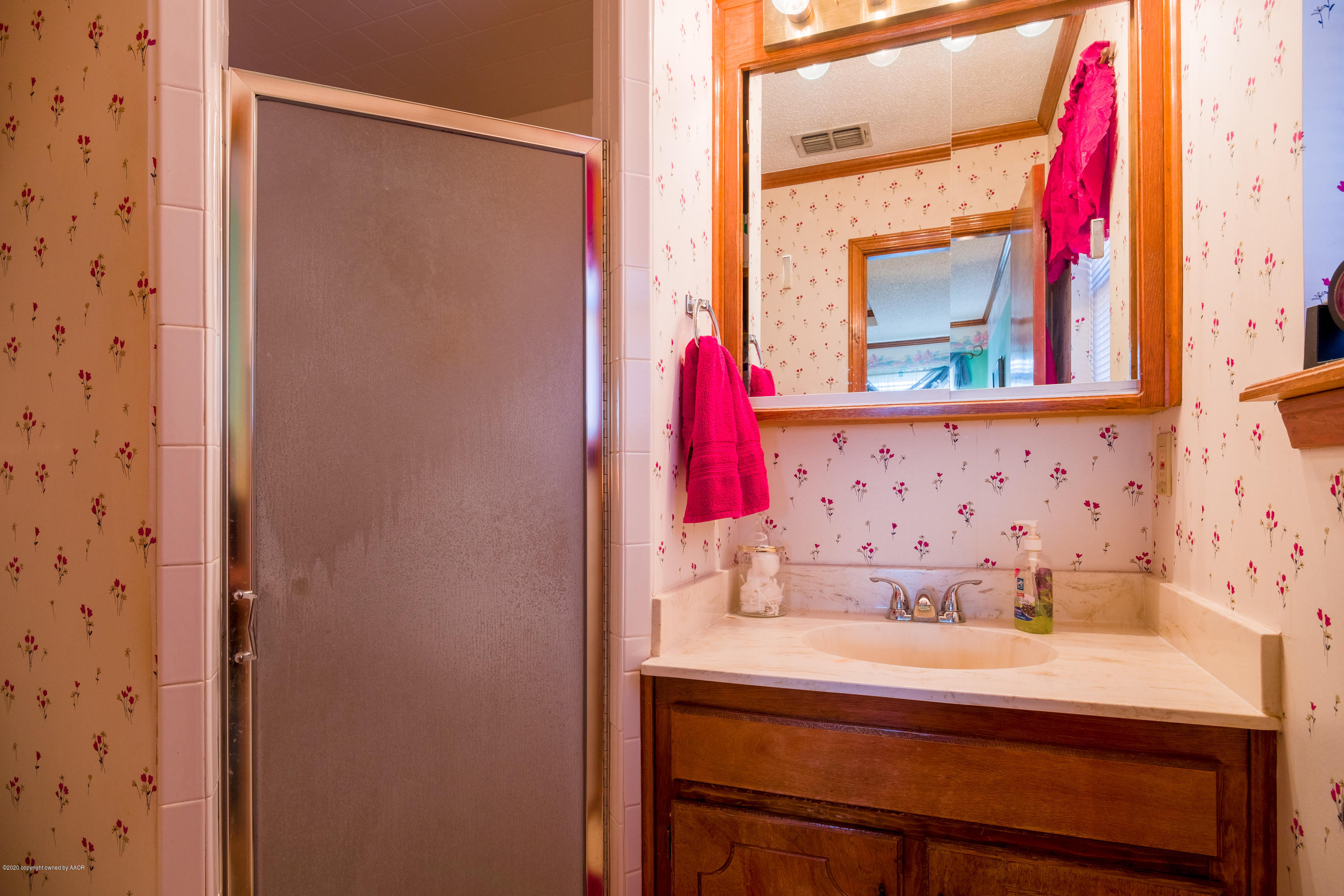 5718 South Fannin Street Amarillo, TX 79110 - Photo 20 of 31 a bathroom with a sink and a mirror