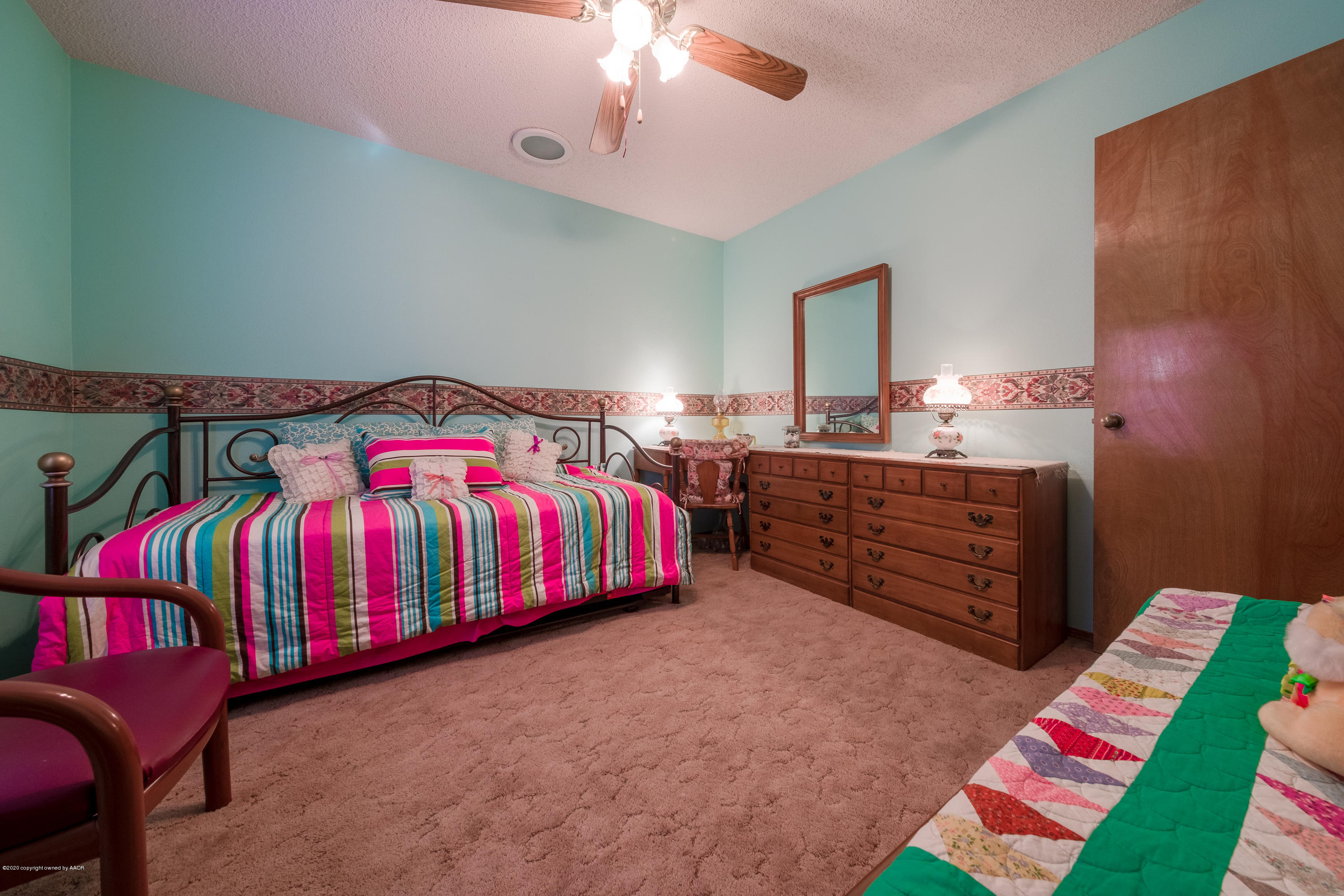 5718 South Fannin Street Amarillo, TX 79110 - Photo 23 of 31 a bedroom with a bed and wooden floor