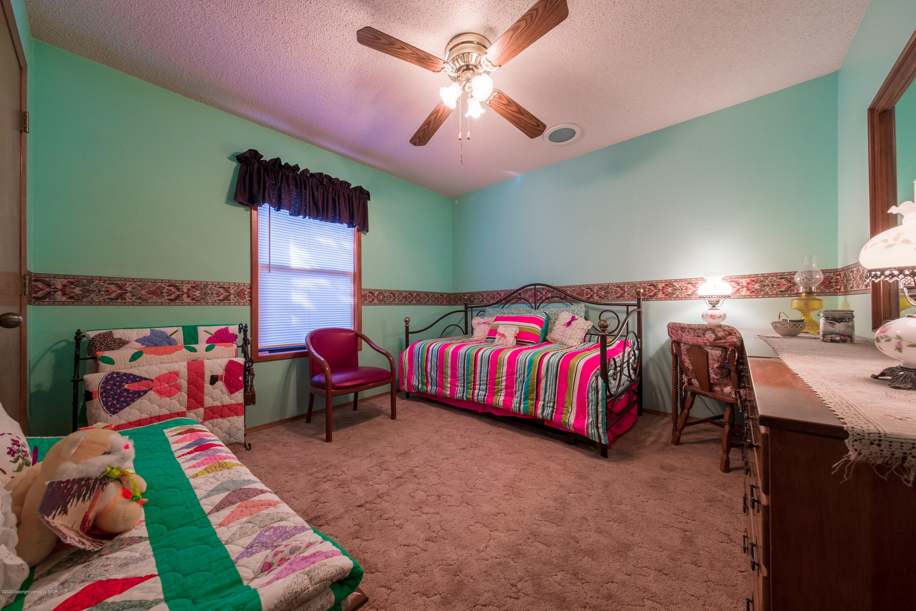 5718 South Fannin Street Amarillo, TX 79110 - Photo 24 of 31 a bedroom with a bed and a lamp