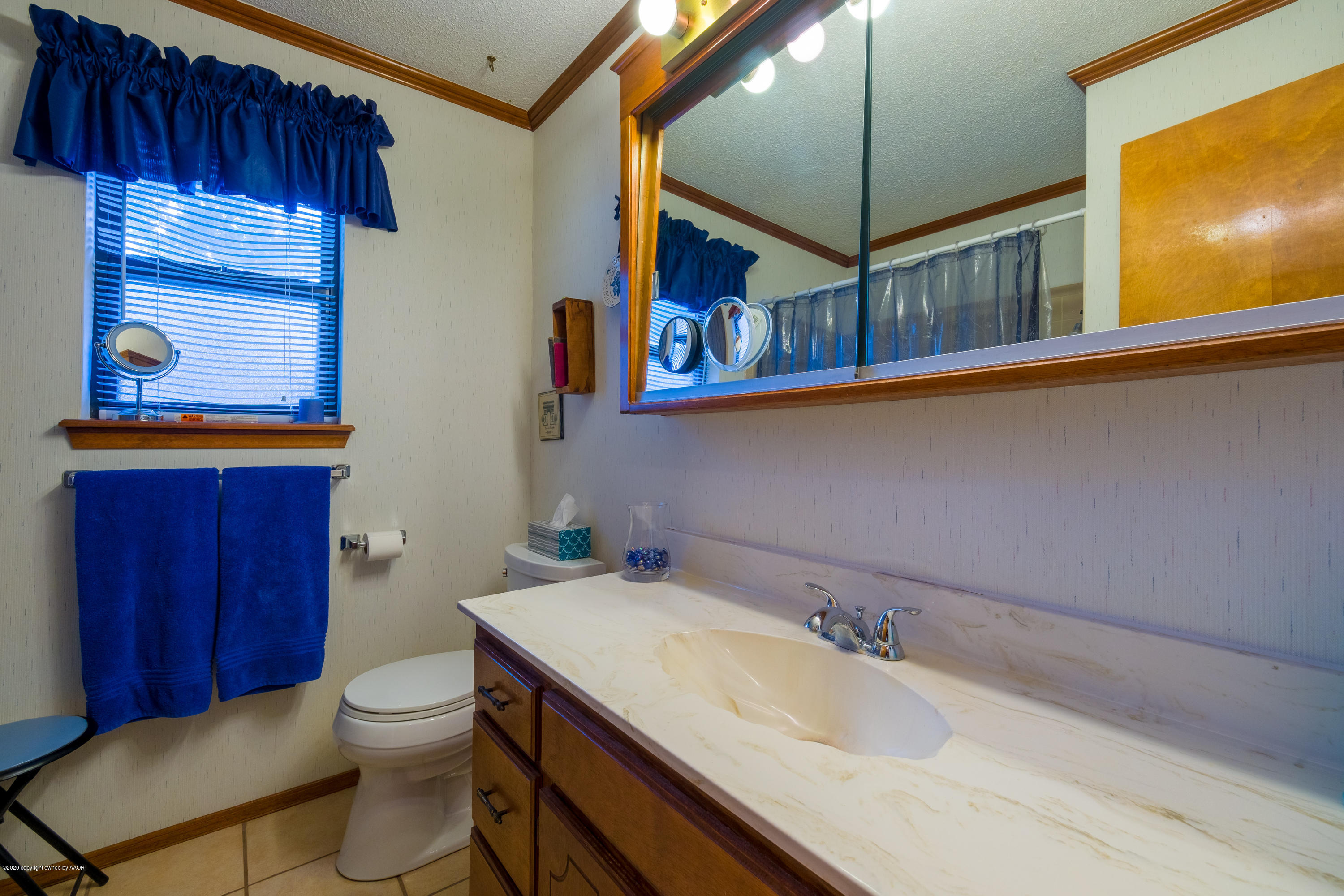 5718 South Fannin Street Amarillo, TX 79110 - Photo 25 of 31 a bathroom with a sink a toilet and mirror