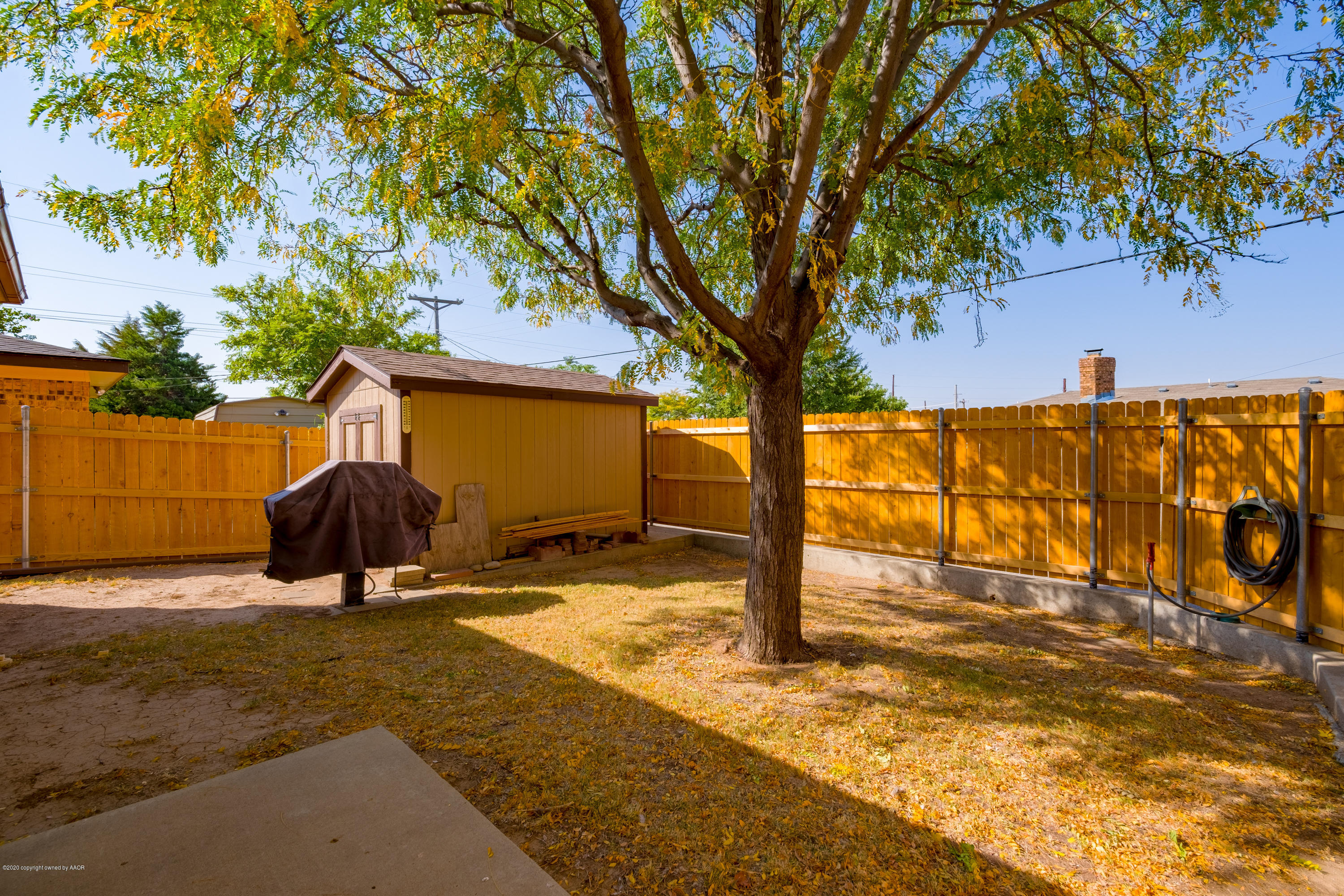 5718 South Fannin Street Amarillo, TX 79110 - Photo 27 of 31 a view of a backyard with a tree