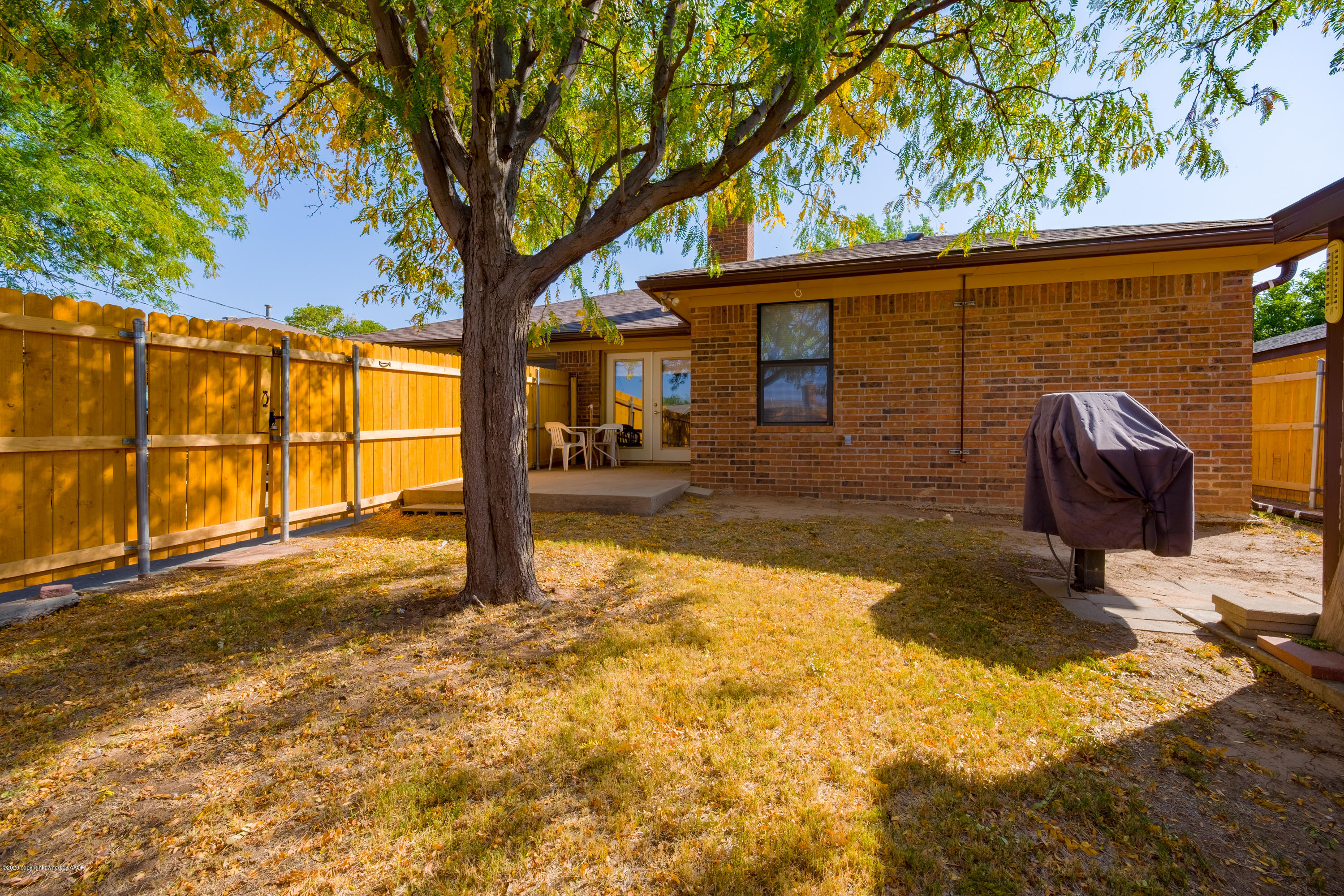 5718 South Fannin Street Amarillo, TX 79110 - Photo 28 of 31 a backyard of a house with barbeque oven table and chairs