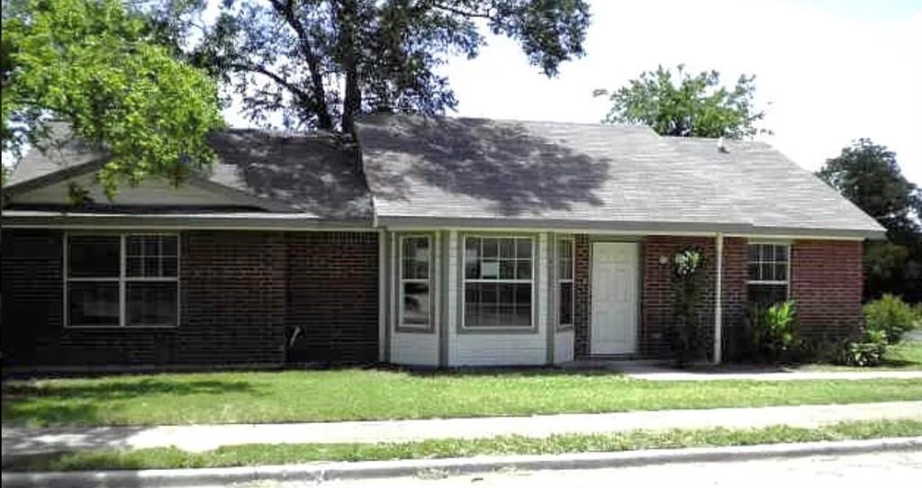 Ranch-style home featuring covered porch, a front lawn, and brick siding