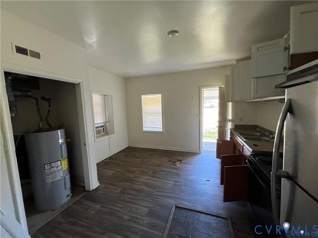703-705 Harding Street Petersburg, VA 23803 - Photo 5 of 14 a view of a kitchen with refrigerator and wooden floor