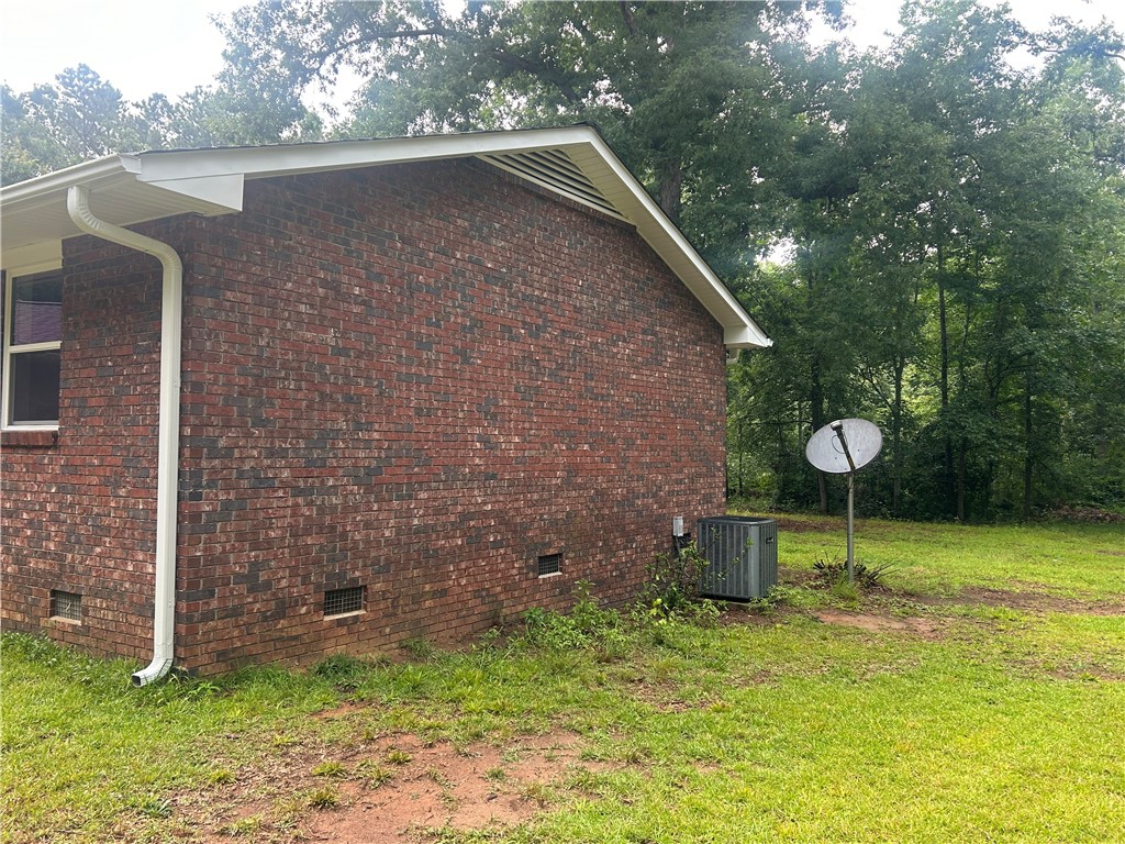 809 Paige Road Honea Path, SC 29654 - Photo 5 of 27 A well-maintained brick exterior property sits nestled within a lush, verdant yard.