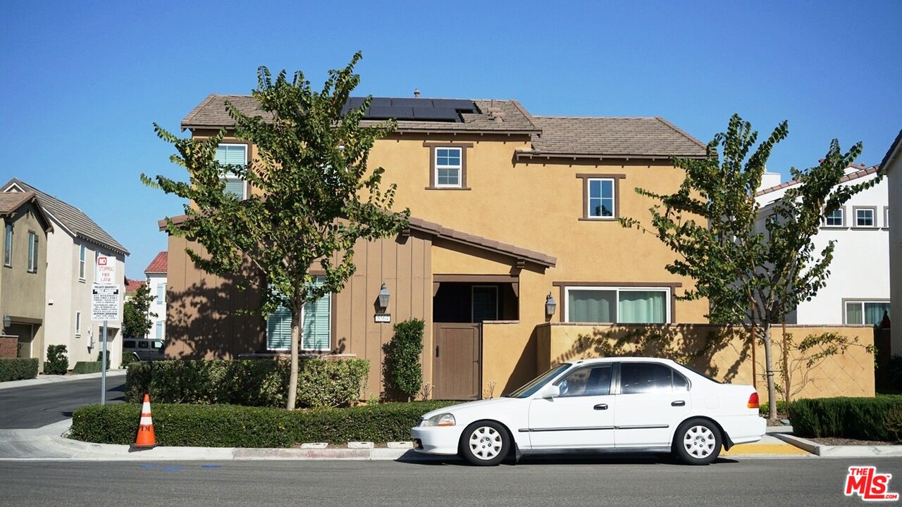 8564 Exposition Street Chino, CA 91708 - Photo 2 of 29 a car parked in front of a white house