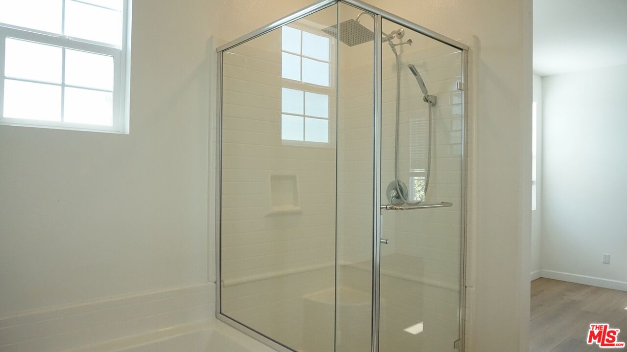 8564 Exposition Street Chino, CA 91708 - Photo 29 of 29 a bathroom with a glass shower door