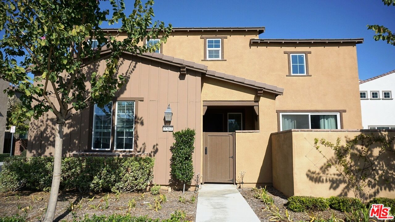 8564 Exposition Street Chino, CA 91708 - Photo 5 of 29 a front view of a house with a tree