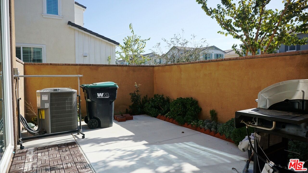 8564 Exposition Street Chino, CA 91708 - Photo 6 of 29 a view of a patio with table and chairs and potted plants