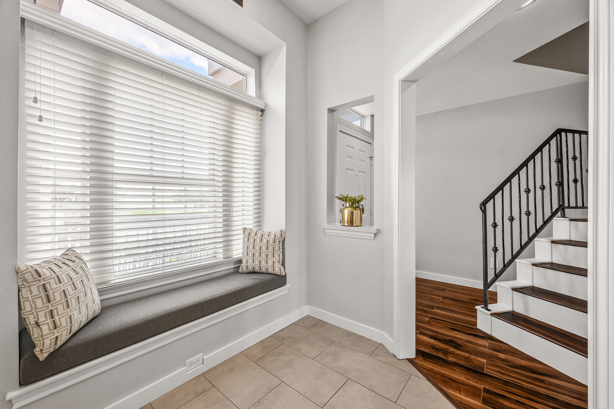 2918 Ranch Road 620 North, Unit S242 Austin, TX 78734 - Photo 8 of 35 A window seat offers a cozy retreat, complemented by the elegant dark wood and white staircase.