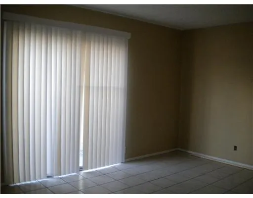 a kitchen with a refrigerator and cabinets