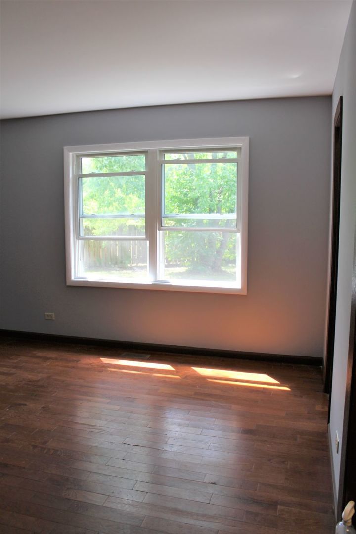 1391 Rennet Drive Naperville, IL 60565 - Photo 13 of 21 an empty room with wooden floor and windows
