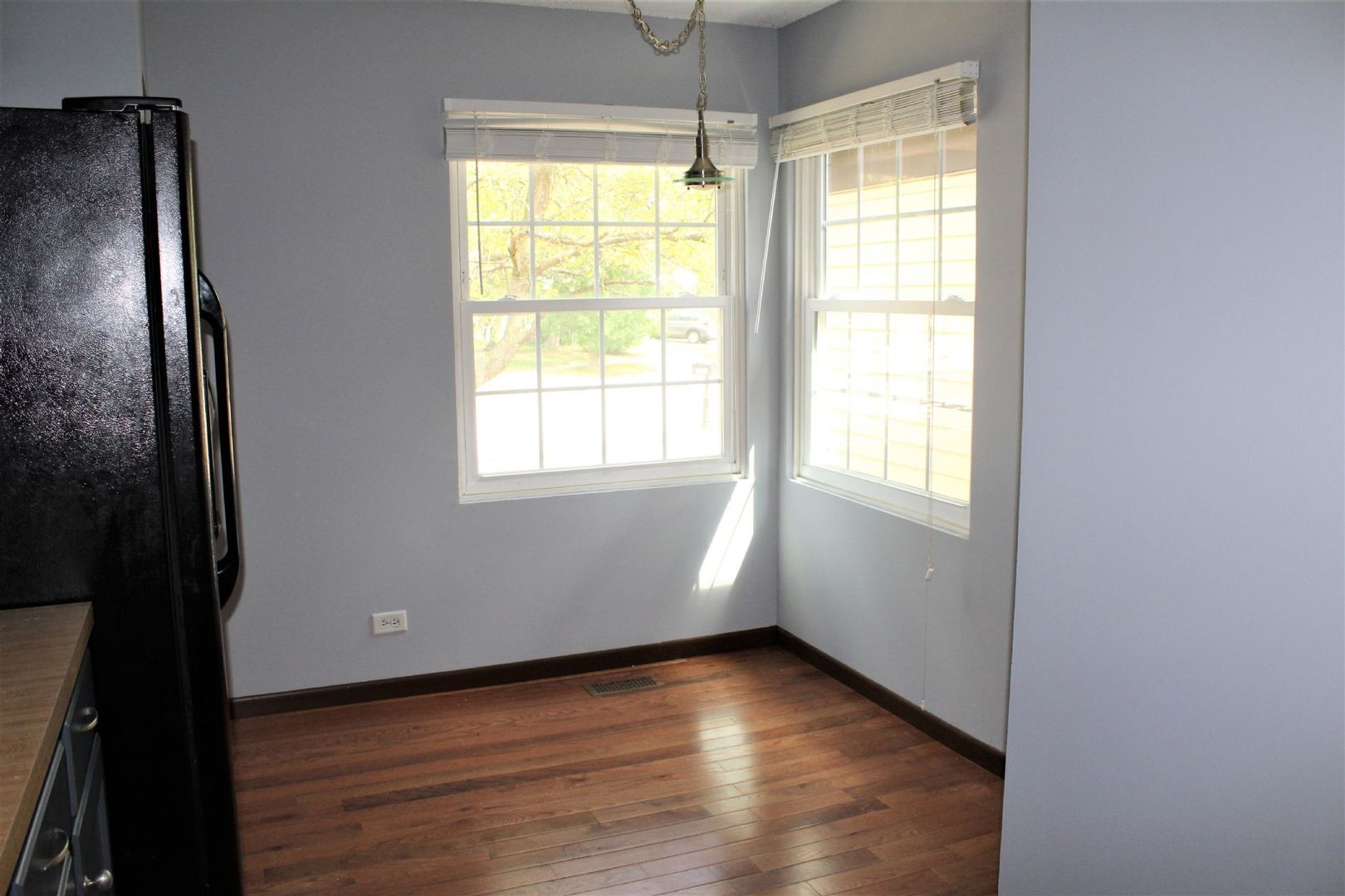 1391 Rennet Drive Naperville, IL 60565 - Photo 6 of 21 a view of an empty room with wooden floor and a window