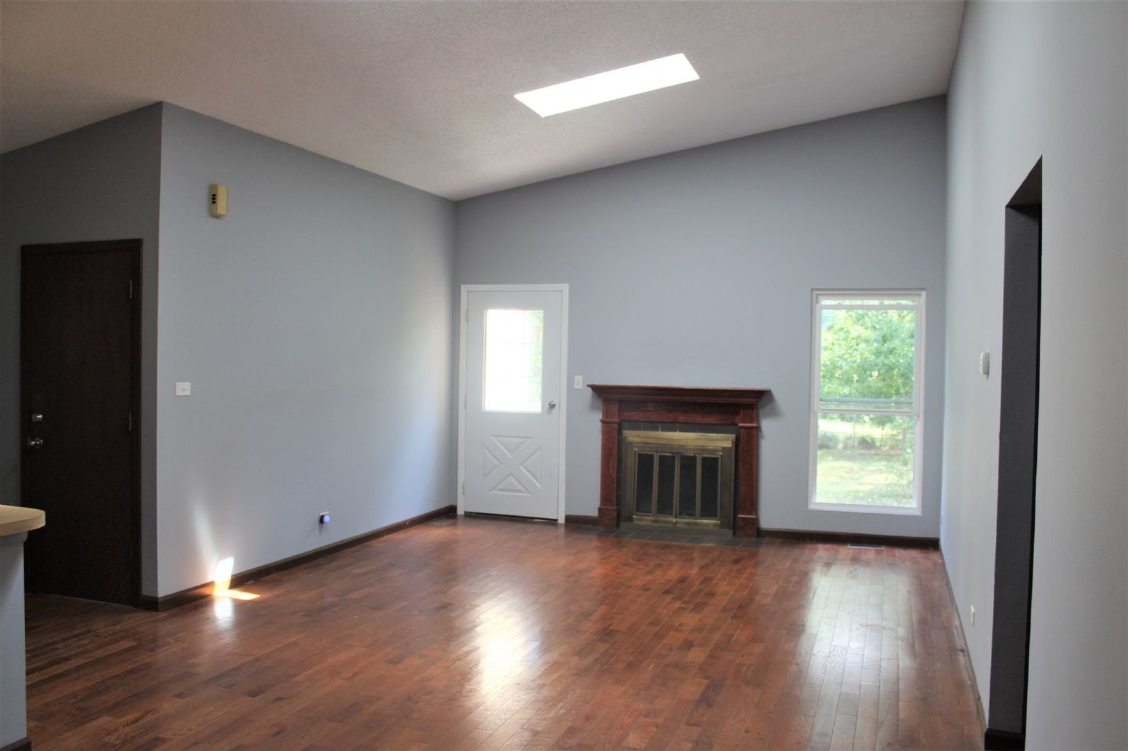 1391 Rennet Drive Naperville, IL 60565 - Photo 8 of 21 an empty room with wooden floor fireplace and windows