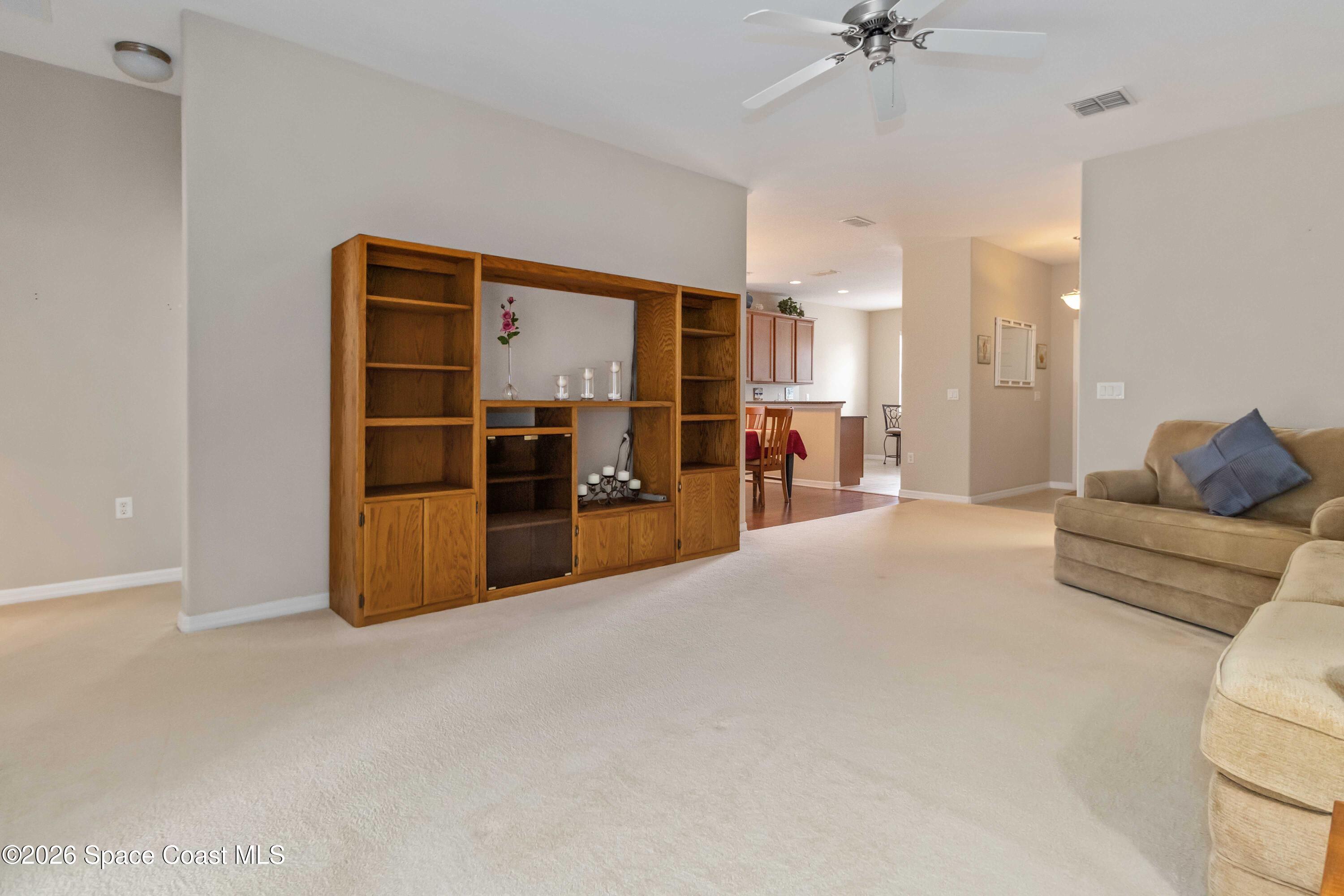 6604 Pico Street Melbourne, FL 32940 - Photo 13 of 36 a living room with furniture and a kitchen