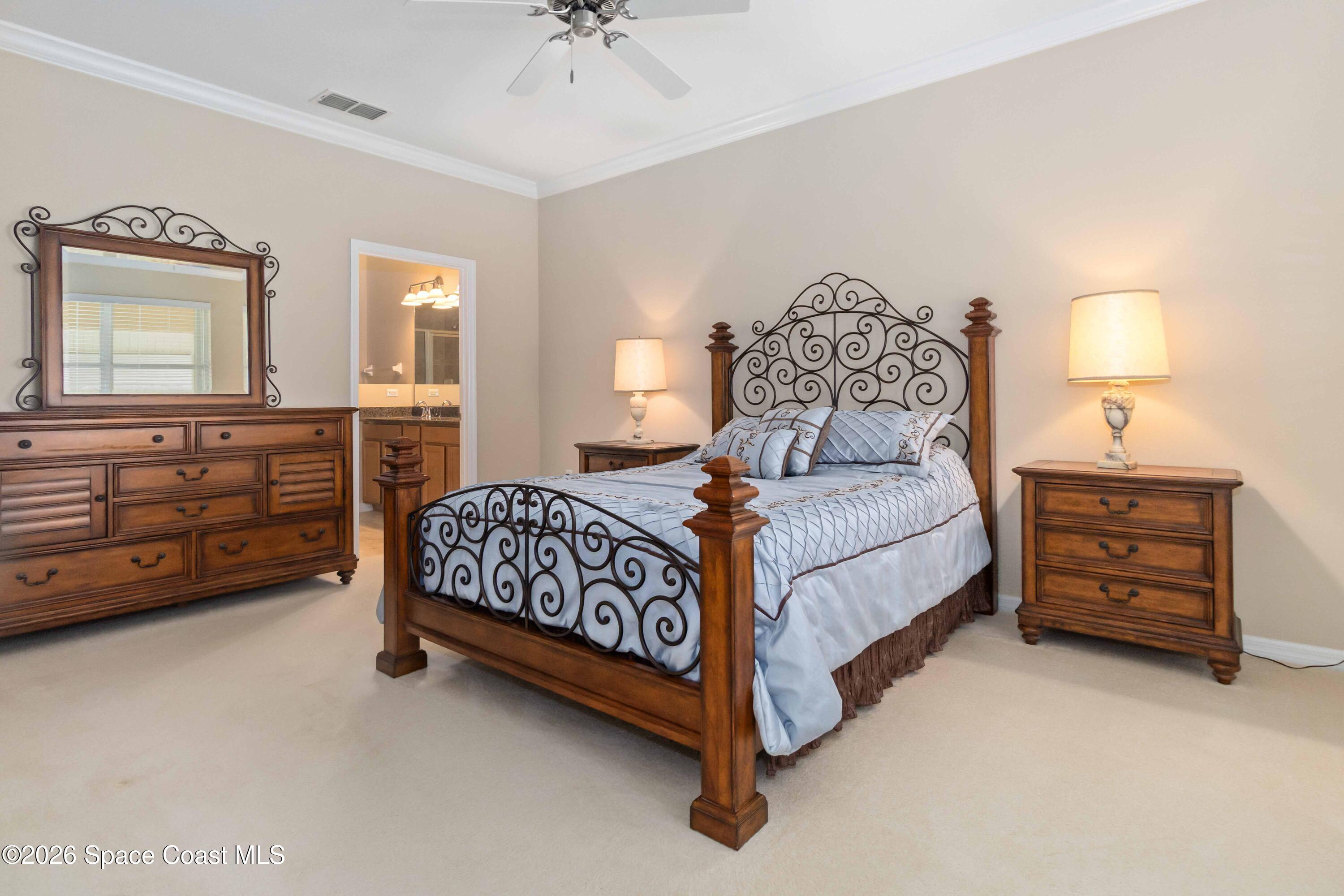 6604 Pico Street Melbourne, FL 32940 - Photo 14 of 36 a bedroom with a bed and a dresser