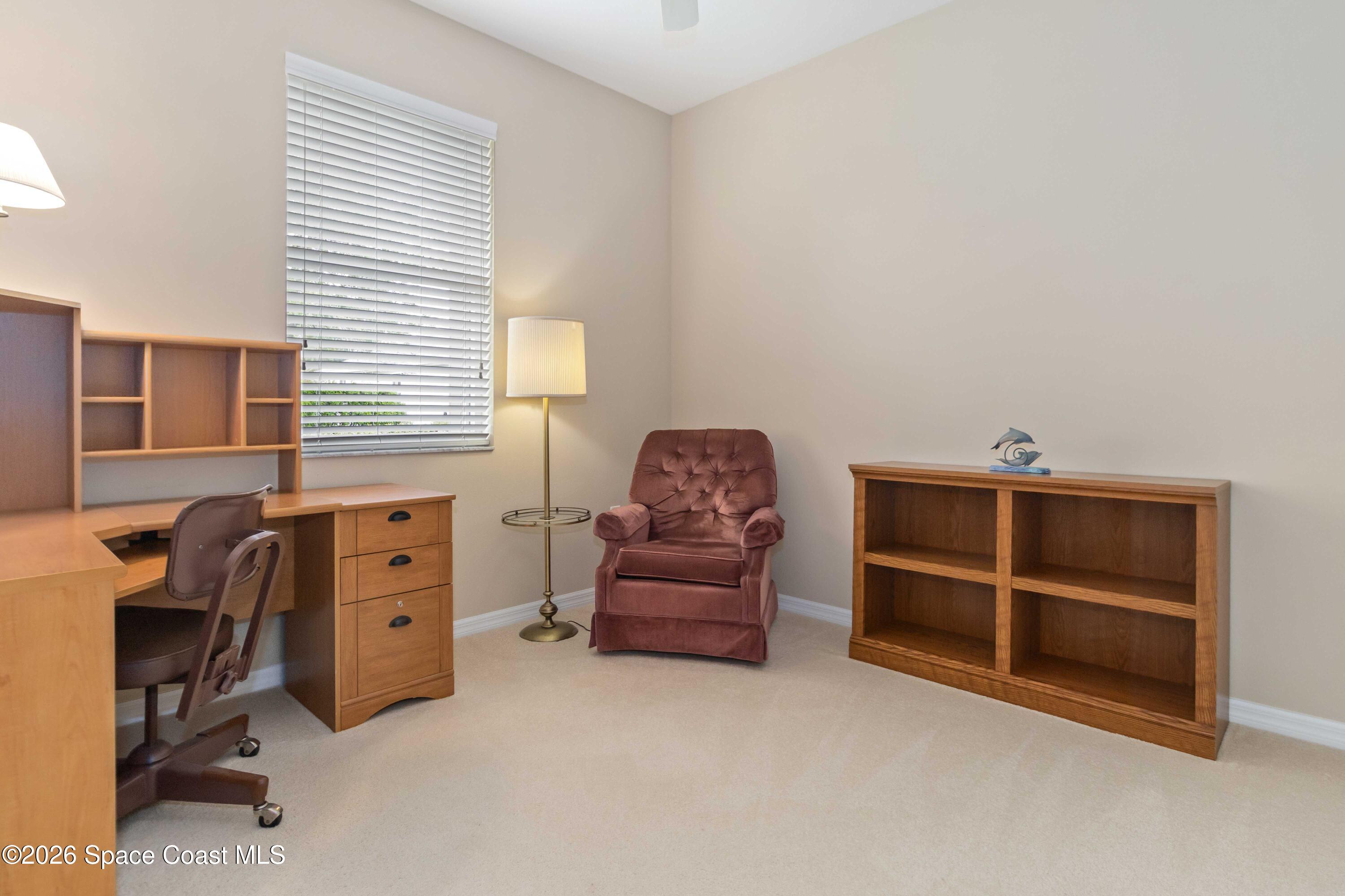 6604 Pico Street Melbourne, FL 32940 - Photo 17 of 36 a bedroom with a bed and a chair