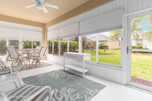 a living room with couches and a bookshelf