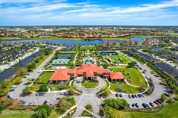 a front view of a house with yard and green space