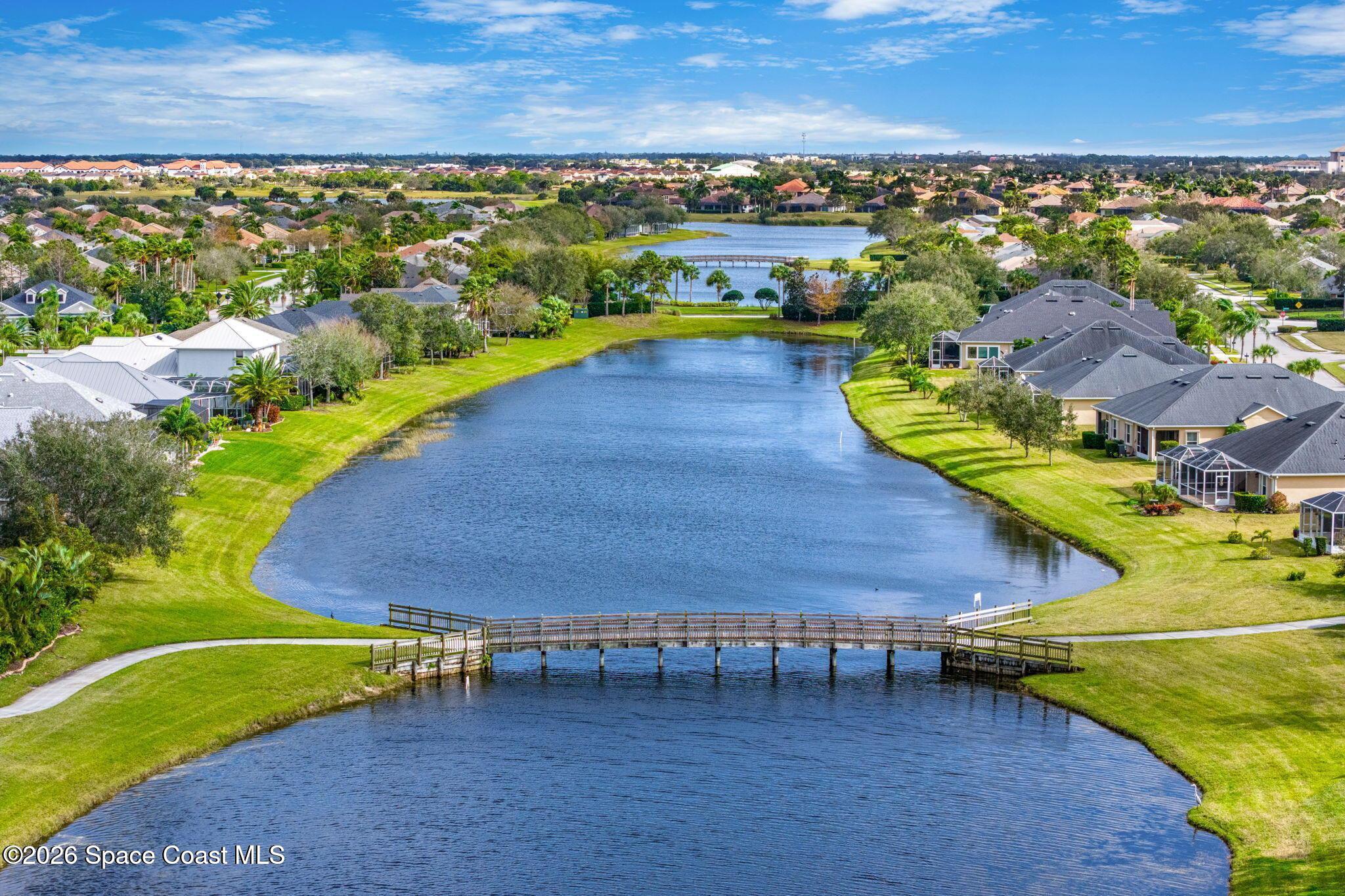 6604 Pico Street Melbourne, FL 32940 - Photo 32 of 36 an aerial view of a house with a yard lake view and mountain view