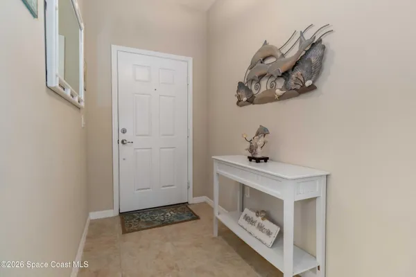 a kitchen with stainless steel appliances kitchen island granite countertop a refrigerator a stove a sink a oven with a dining table and chairs