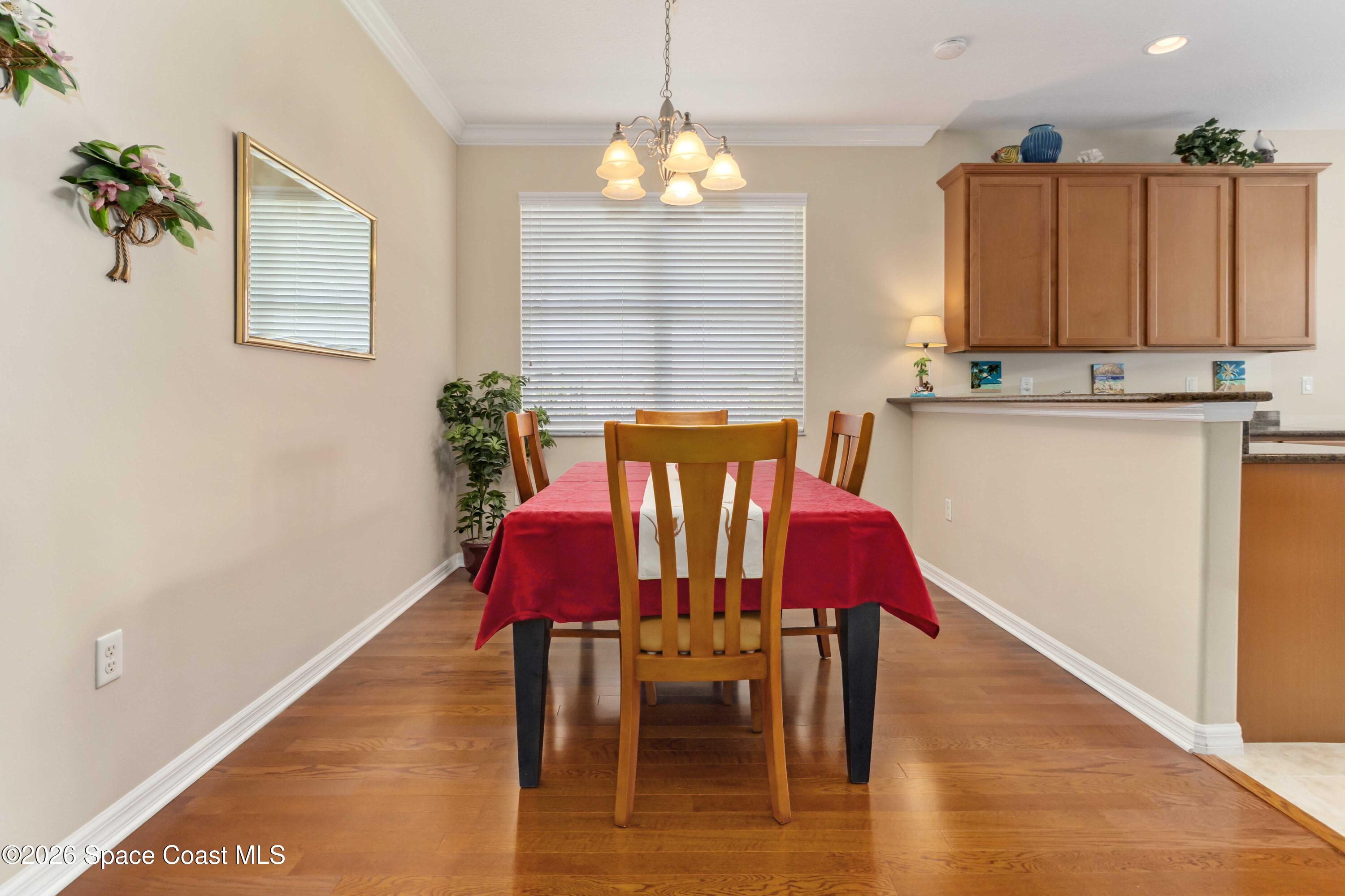 6604 Pico Street Melbourne, FL 32940 - Photo 9 of 36 a view of a dining room with furniture and wooden floor