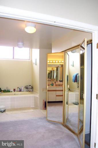 11206 Harbor Court, Unit 1206 Reston, VA 20191 - Photo 14 of 17 Walk-in closet with trifold mirrored doors.